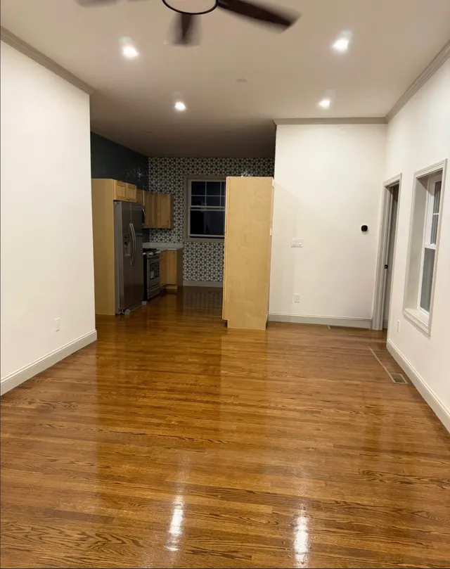 Open interior with light walls and wood flooring