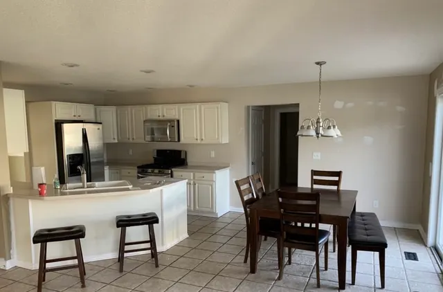 White kitchen cabinets and a dining area