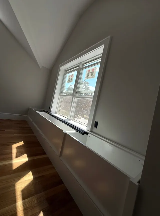 Interior stairwell with light walls and a window
