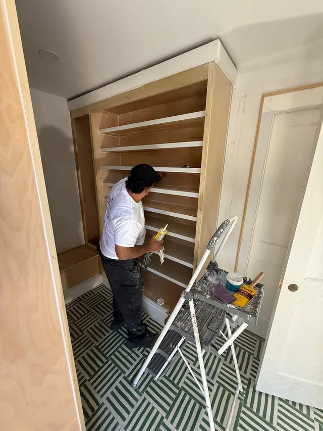 Crew member working beside shelving with protected flooring