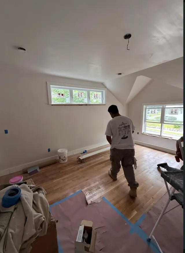 Crew member working in a room with protected wood flooring