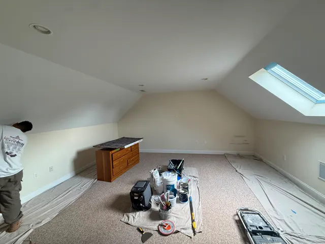 Attic room with sloped ceilings and project materials