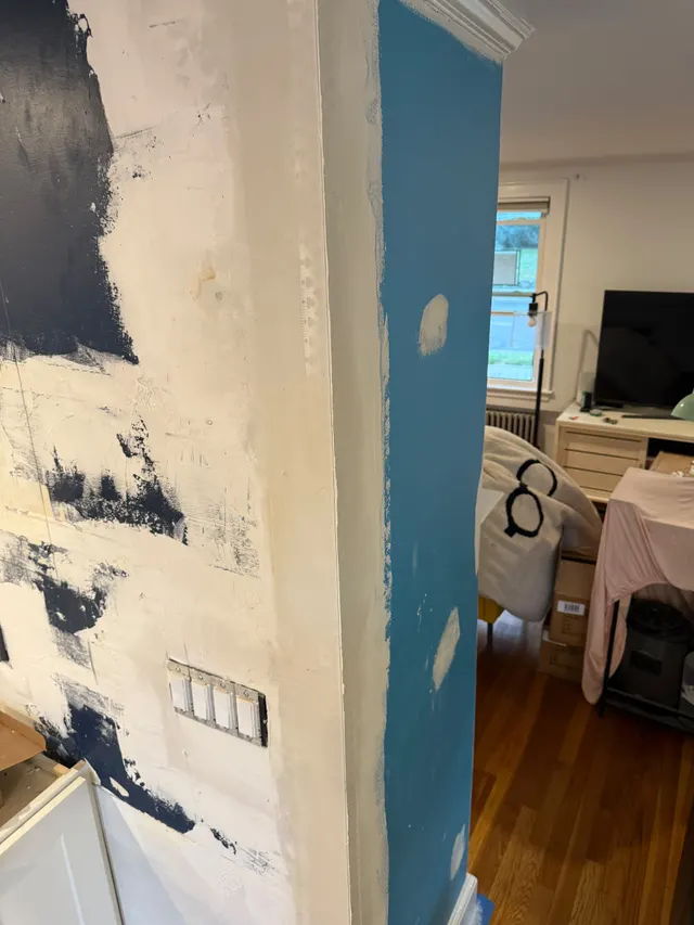 Interior wall with patched areas before finishing