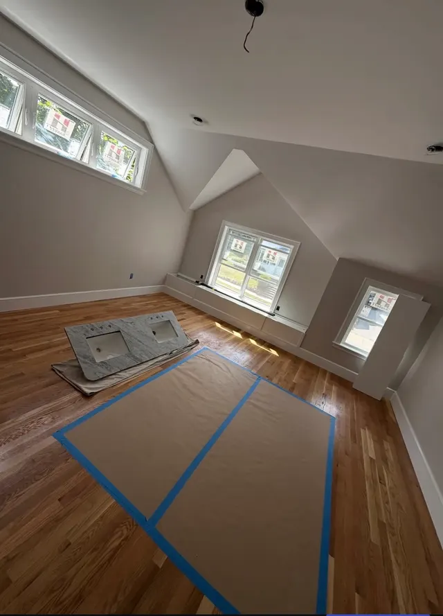 Taped floor protection beneath interior walls and windows