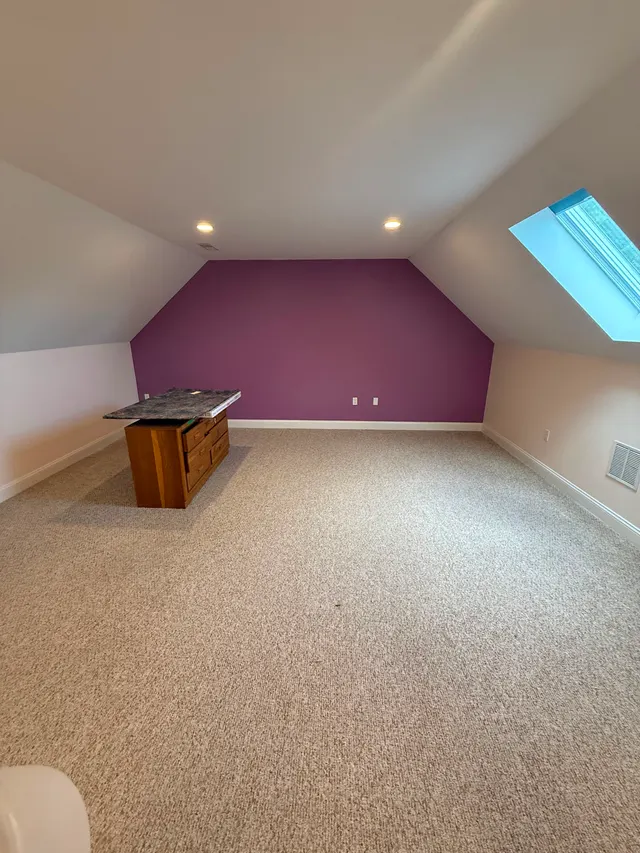 Attic room with a purple accent wall before updates