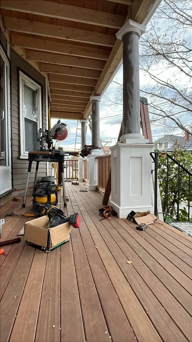 Covered porch with wood flooring and project materials