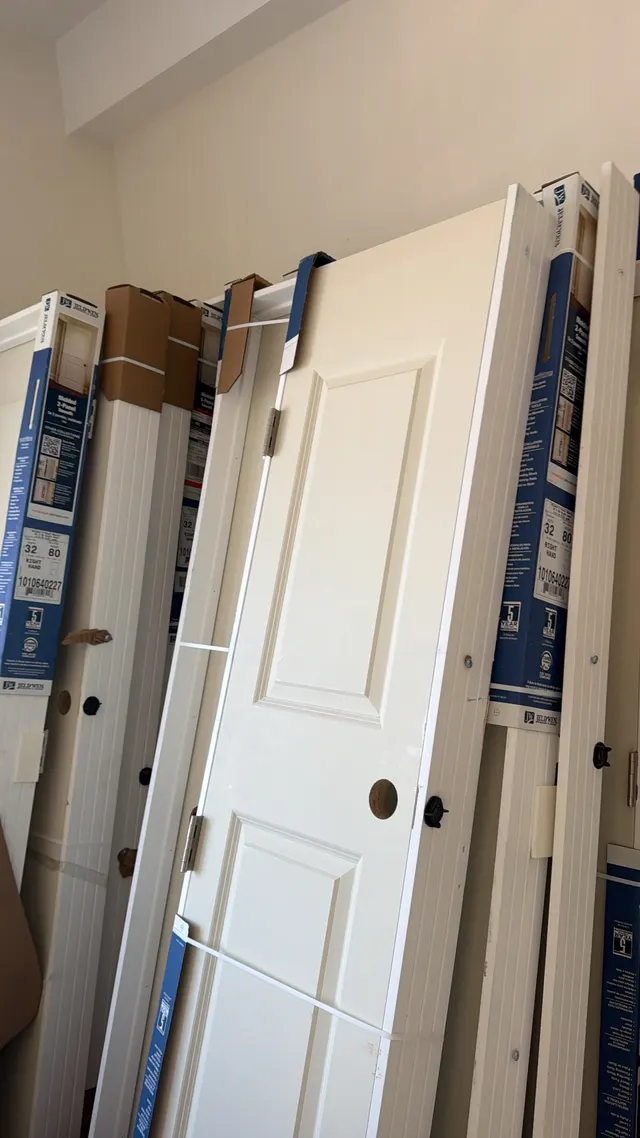 White paneled door and trim in an interior hallway