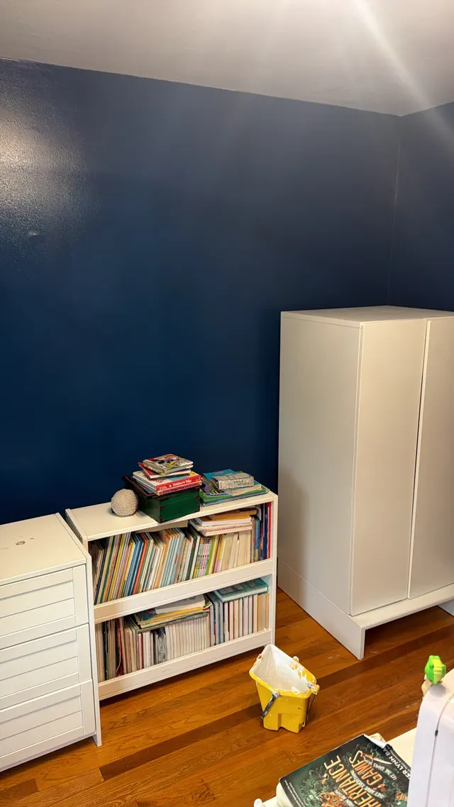 Blue interior walls with white trim and a doorway